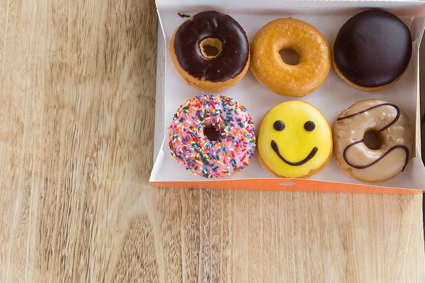 Colorful donuts in box