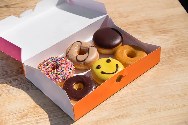 Colorful donuts in box