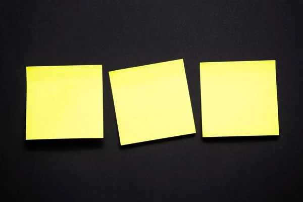 Yellow sticky notes on black background