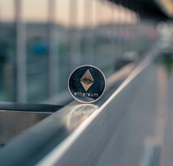 Silver Ethereum stand on metal handrail