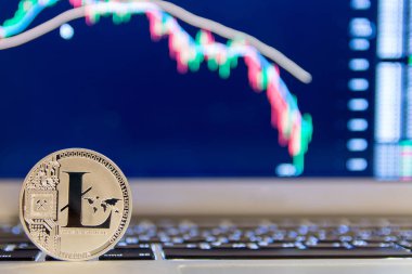 Grafik azalan ile defter keydoard üzerinde gümüş Litecoin