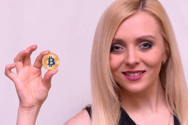 güzel bir sarışın kızın elinde altın bitcoin 
