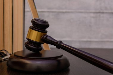 Yargıç tokmak yanında yığın kitap ahşap arka plan üzerinde