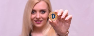 güzel bir sarışın kızın elinde altın bitcoin 