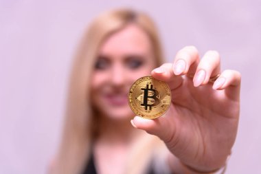 güzel bir sarışın kızın elinde altın bitcoin 