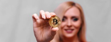 güzel bir sarışın kızın elinde altın bitcoin 