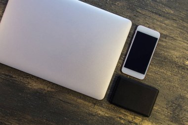 Metin kopyalama yeri olan eski bronz arka plan üzerinde tablo ya da dizüstü bilgisayar, siyah sabit disk ve akıllı telefon Danışma üstten görünüm.