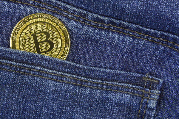 Bitcoin lies in the pocket of blue jeans