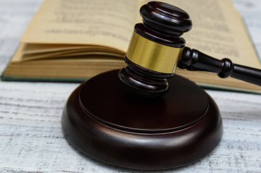 Yargıç tokmak yanında yığın kitap ahşap arka plan üzerinde
