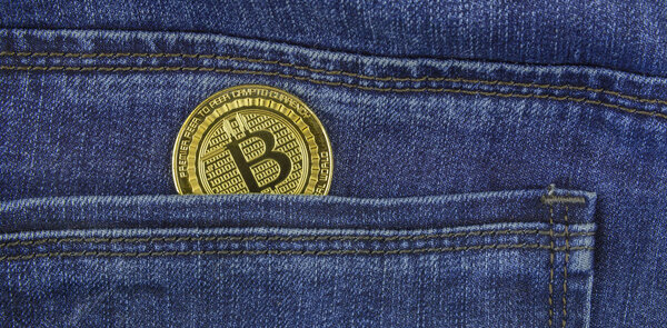 Bitcoin lies in the pocket of blue jeans