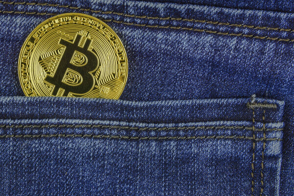 Bitcoin lies in the pocket of blue jeans