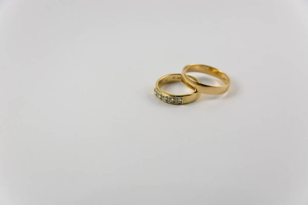 studio shot of golden wedding rings isolated on white background