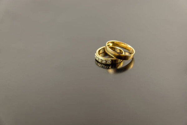 two wedding rings isolated on dark background