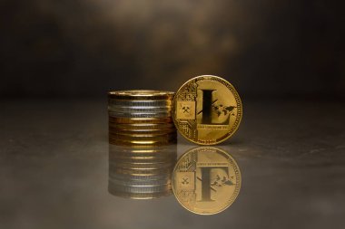 yansıtıcı yüzeyüzerinde altın Litecoin ve sikke yığını