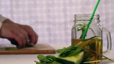 Pouring healthy cucumber mint refreshing detox drink 4k close up selective shot