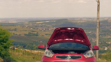 Broken down car with smoke coming out of engine wide 4k shot selective focus