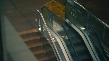Escalator moving staircase in shopping mall wide top view 4k shot selective focus