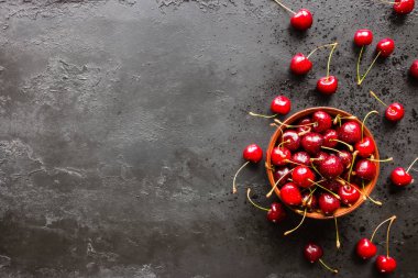 Taze kiraz bir plaka ve siyah bir zemin üzerine