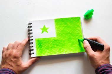 man draws the flag of Esperanto clipart