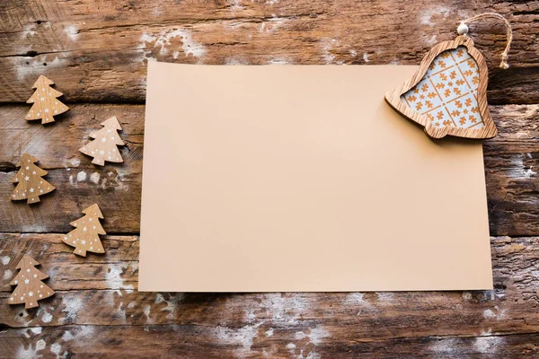 empty christmas letter and wooden ornaments