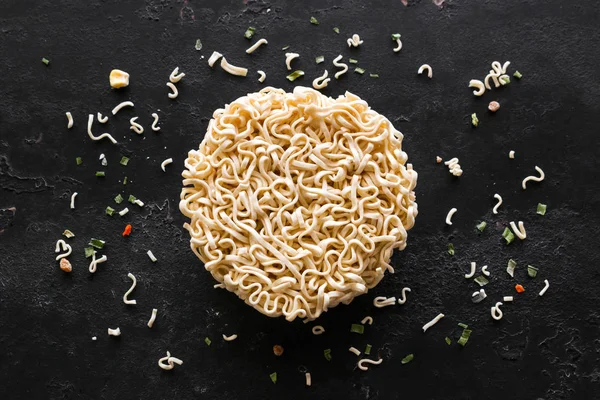 dry instant noodles round shape on black background