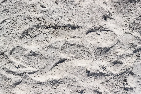 Footprint on white sand or dust. The trail of man on lunar soil or desert.