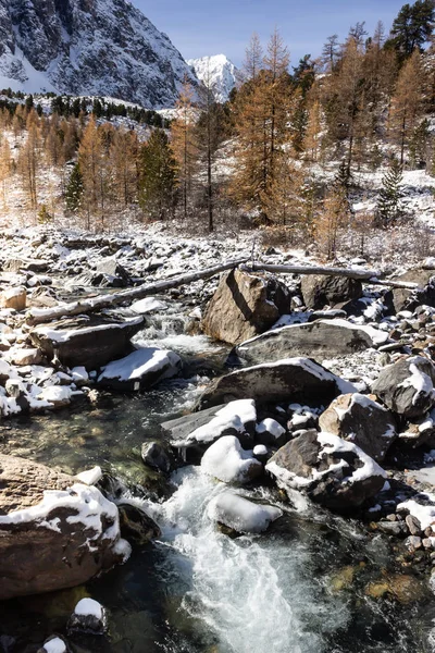 Mountain river, rocks in snow. Winter trip in mountains