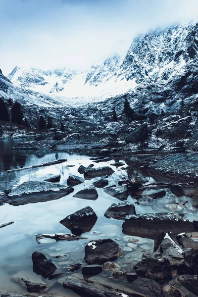 Mountain lake, rocks are reflected in water surface