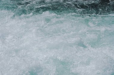 Dağ nehrinin mavi köpüren suyu. Turkuaz denizin okyanus gelgiti