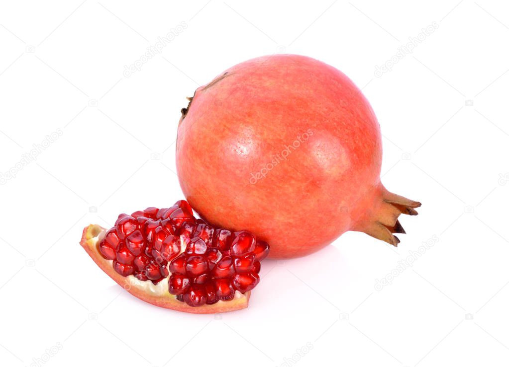 whole and cut fresh pomegranate fruit on white background
