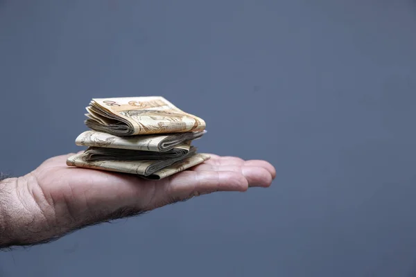 Hands holding Brazilian real notes - Money from Brazil - Notes o