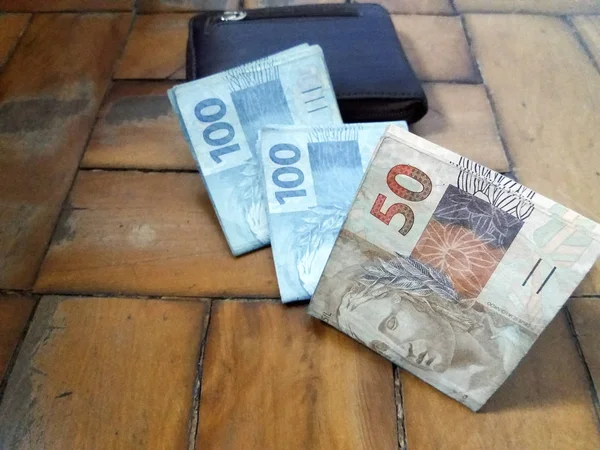 Hands holding Brazilian real notes - Money from Brazil - Notes o