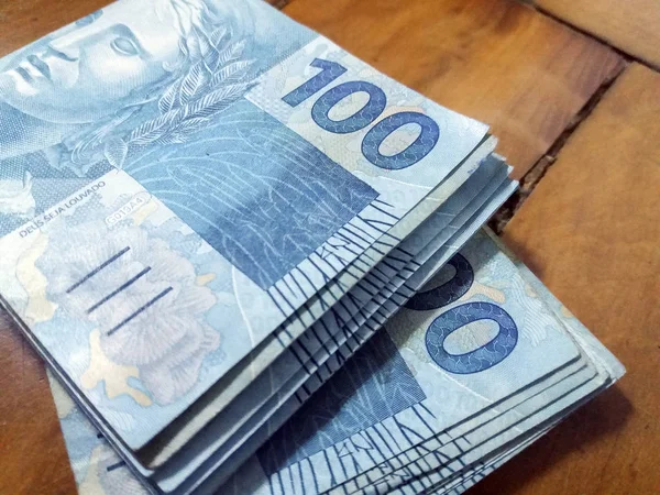 Hands holding Brazilian real notes - Money from Brazil - Notes o
