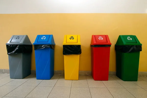 several plastic bins with different colors for garbage collection and separation