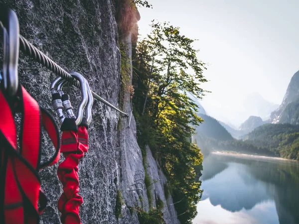 snap hooks in the steel rope, behind the dachstein mountain