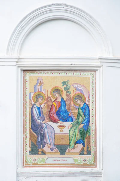 Mosaic of the Holy Trinity on the outside of the Christian Church. Holy Trinity Church in Tomsk, Russia. Translation: \