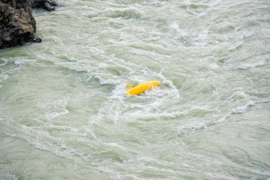 Sarı bir kayık üzerinde Kayaker dağ nehri Katun, Altay dağları, Rusya üzerinde baş aşağı döndü. 