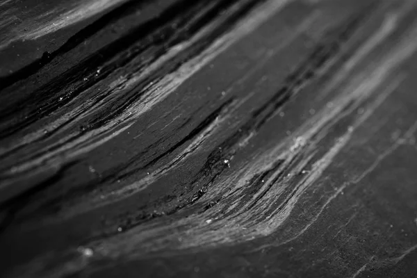 Black glossy background of painted wood planks.