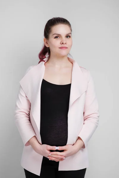 Young pregnant woman in business casual suit on white background. — Stock Photo, Image