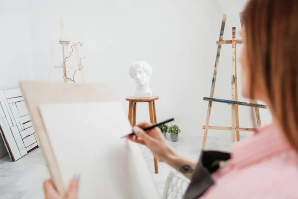 Młoda kobieta artysta rysuje ołówkiem na płótnie. — Zdjęcie stockowe