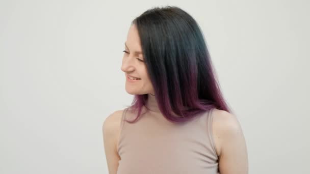 Portrait of a young woman on a white background. Long dyed hair. Ombre, color staining. Lilac and blue. — Stock Video