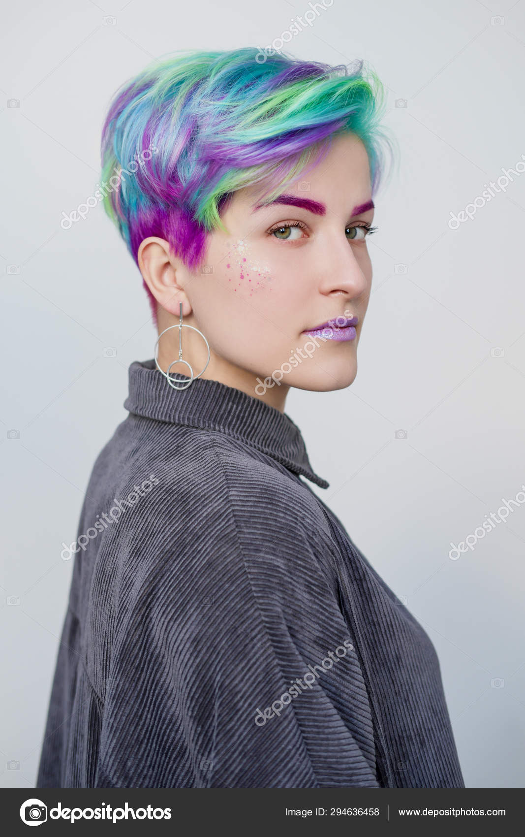 Young beautiful woman with dyed blue and green hair. Pixie bob short haircut  The concept of hair styling. Stock Photo by ©spaskov 294636458