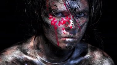 Siyah arka planda güzel beyaz bir kadının moda portresi. Parlak renkli yaratıcı makyaj. Dramatik karanlık görüntü. Kirli bir yüzün kan damlalarıyla etkisi.