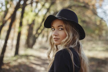 Kadın güzellik konsepti. Zarif saç stili olan çekici bir kadının yakın plan portresi. Moda dışarıda çekiliyor.