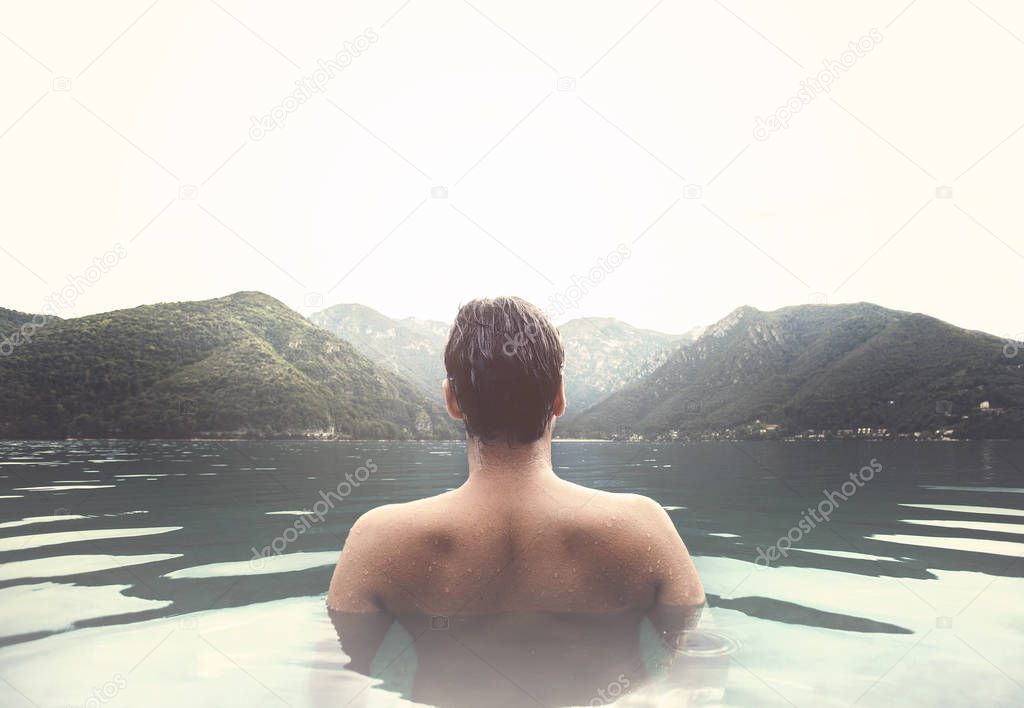 man relaxing in a natural hot bath