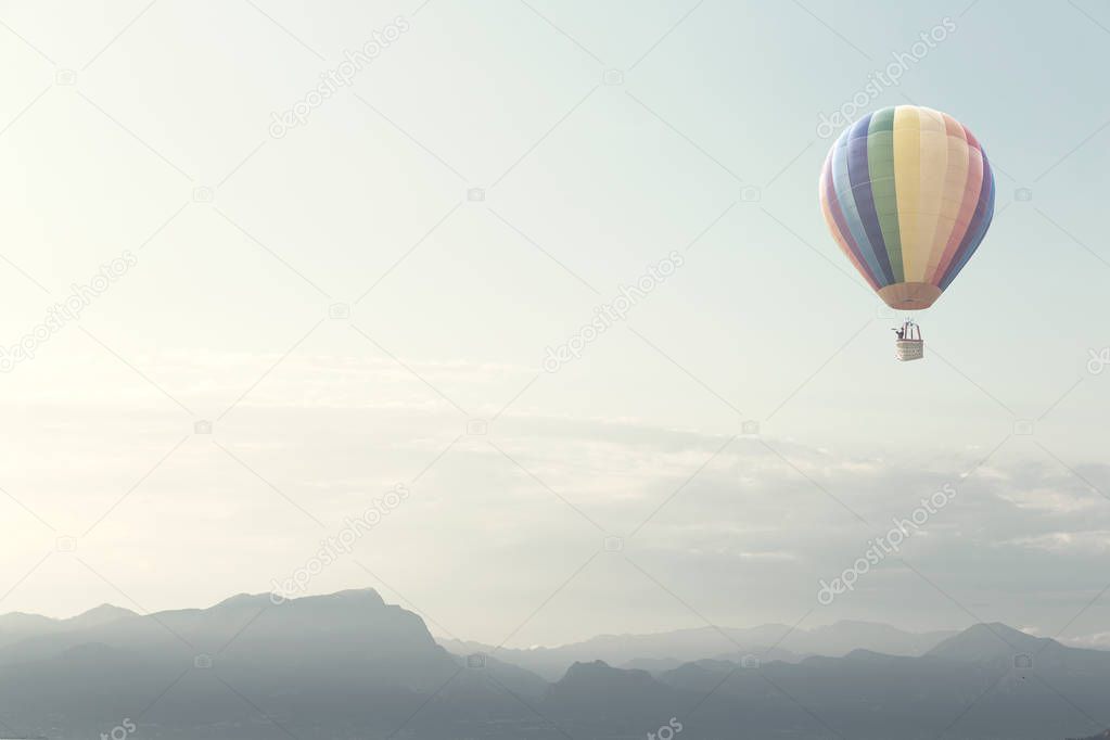 big balloon flying over mountains