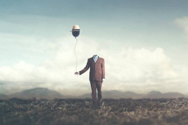 adam baş olmadan şapka gerçeküstü konsepti ile siyah balon tutar