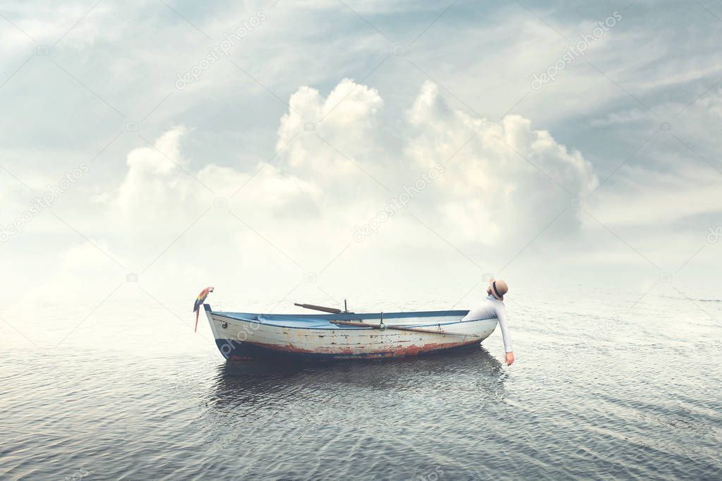 man relaxing on old boat floating in the calm water