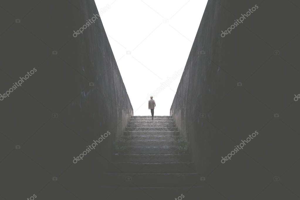 man rising dark stair to reach the light