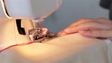 O kumaş keser ve bir makinede diker gibi bir dikiş proje üzerinde çalışan bir kadın. dikiş makinesi yakın bir bez dikiş sırasında bir makinede destekleyen bir terzi bir el kadar.